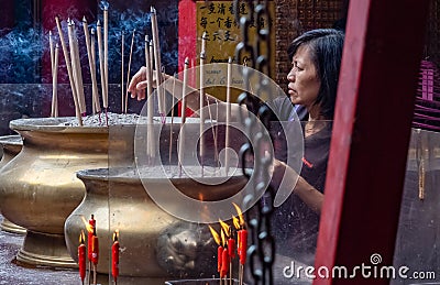 Woman Praying In A Chinese Temple In Kuala Lumpur, Malaysia Editorial Stock Photo