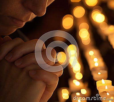 Woman praying in church cropped portrait Stock Photo