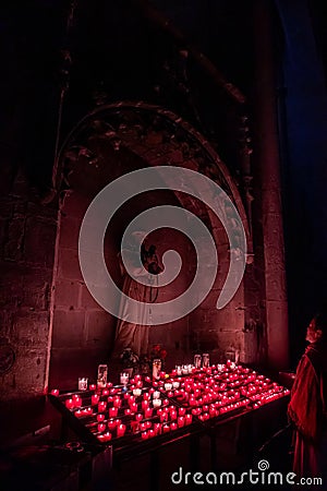 Woman praying inside a catholic church in France Editorial Stock Photo