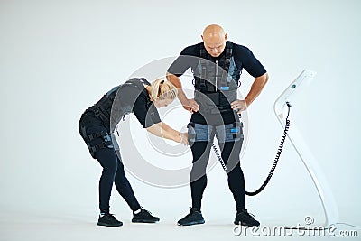 Woman preparaing man for fitness training Stock Photo