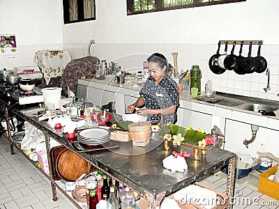 Woman prepares in the kitchen a duck balinese style Editorial Stock Photo