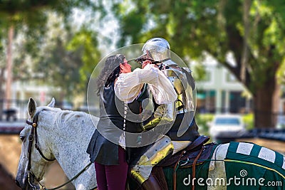 A woman prepares a knight for a joust at Camelot Days Medieval Festival - Topeekeegee Yugnee TY Park, Hollywood, Florida, USA Editorial Stock Photo