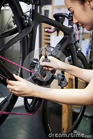 Woman preparing the bike before sale Stock Photo