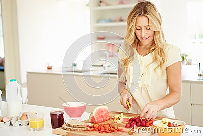 Woman Preparing Healthy Breakfast In Kitchen Stock Photo