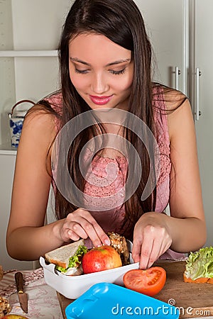 Woman preparing lunchbox Stock Photo