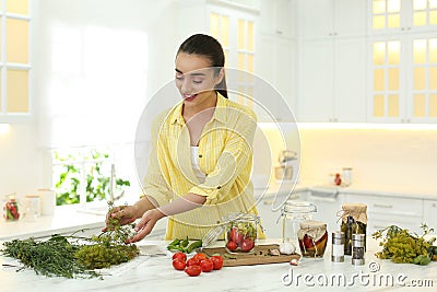 Woman preparing pickled vegetables in kitchen Stock Photo