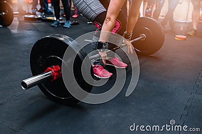 Woman preparing to barbell deadlift Stock Photo