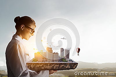 Woman presenting construction model. Mixed media . Mixed media Stock Photo