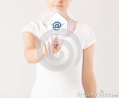 Woman pressing virtual button with e-mail icon Stock Photo