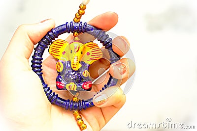 Woman with pretty hands holding beautiful colourful idol of indian god lord ganesha usually sold during ganesha chaturthi and diwa Stock Photo