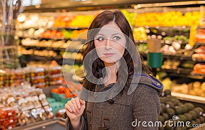 Woman in the produce section of a grocery store. Stock Photo