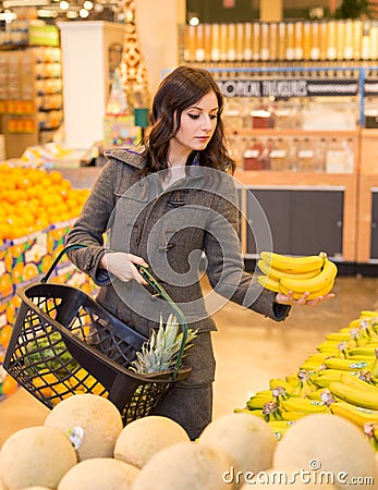 Woman in the produce section of a grocery store. Stock Photo