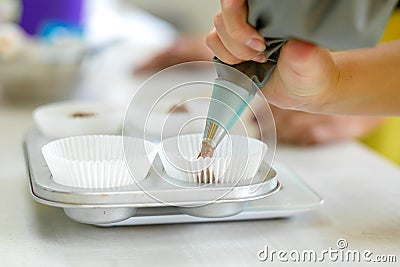 Woman professional pastry chef spreads chocolate dough in baking dish Stock Photo