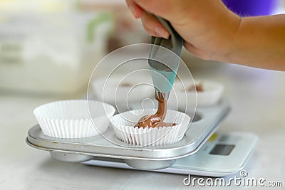 Woman professional pastry chef spreads chocolate dough in baking dish Stock Photo