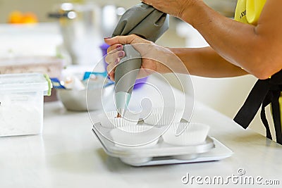 Woman professional pastry chef spreads chocolate dough in baking dish Stock Photo