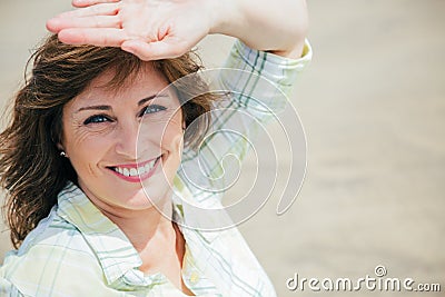 Woman protecting from the sun on the beach Stock Photo