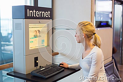 Woman public internet access point on airport. Stock Photo