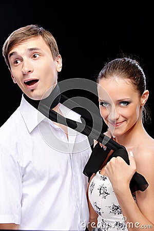 Woman pulls man for scarf Stock Photo