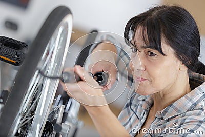 woman pumps up tires bike Stock Photo