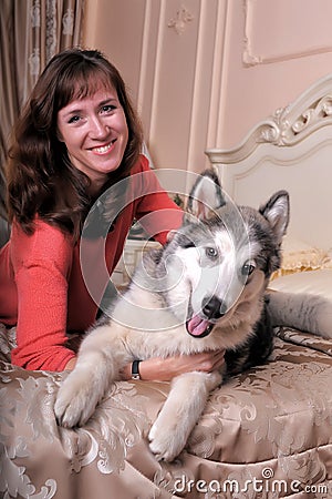 Woman with a puppy Malamute Stock Photo