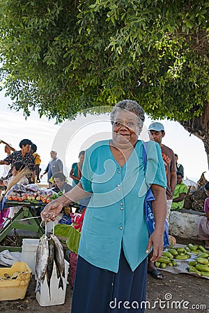 Woman bought fresh catched fish on tropical market on Island in Pacific Ocean Editorial Stock Photo