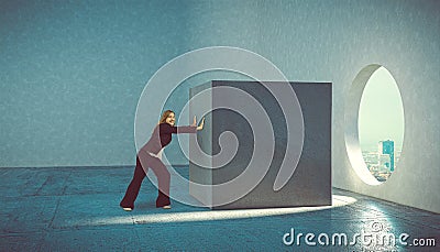 Woman pushes cube concrete block Stock Photo