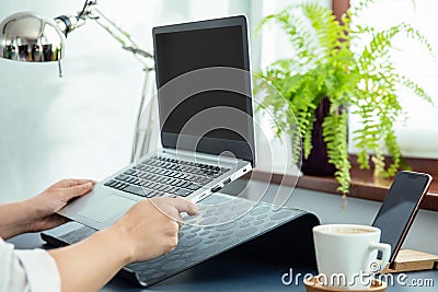 Woman puts ultrabook to laptop`s stand Stock Photo