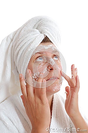 Woman putting cream on her face Stock Photo