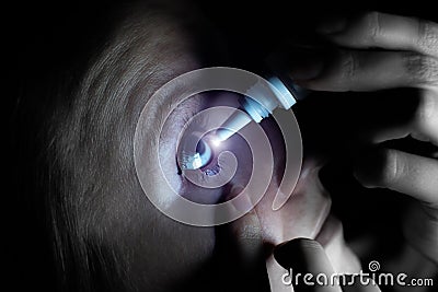 Woman is putting drops in his eyes. Medical treatment concept. Allergic conjunctivitis problem..Works on internet in front of Stock Photo