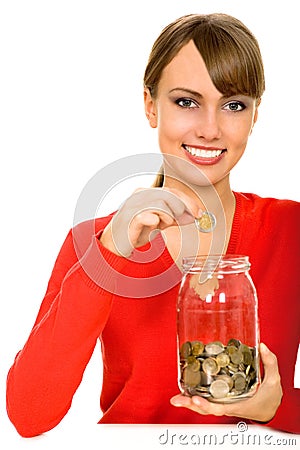 Woman putting money in jar Stock Photo