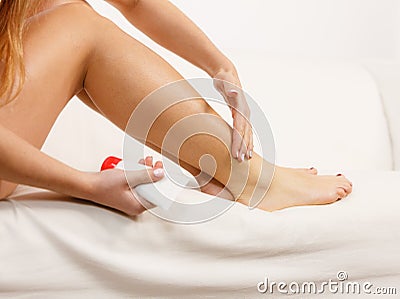 Woman putting ointment on bad ankle applying cream Stock Photo