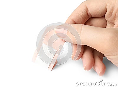 Woman putting sticking plaster on background. First aid item Stock Photo