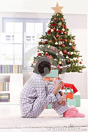 Woman in pyjama on christmas morning Stock Photo