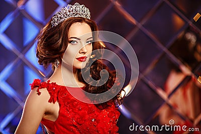 Woman queen princess in crown and lux dress, lights party background Luxury girl Long shiny healthy volume hair Waves Curls Stock Photo