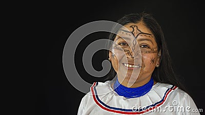 Woman of the Quichua ethnic group of the Ecuadorian Amazon smiling from the front in her traditional dress on a black background Editorial Stock Photo