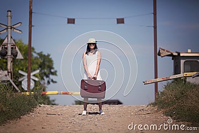 Woman on a railway retro style with a suitcase Stock Photo