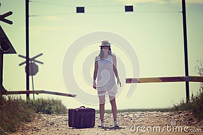 Woman on a railway retro style with a suitcase Stock Photo