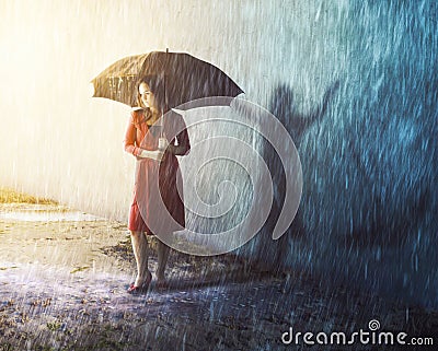 Woman in rain storm with shadow Stock Photo