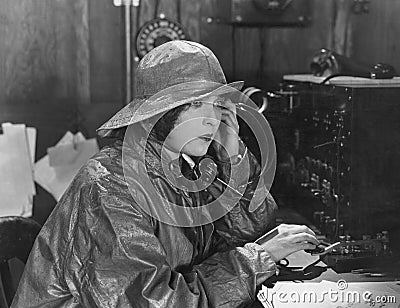 Woman in raincoat sending message in Morse code Stock Photo