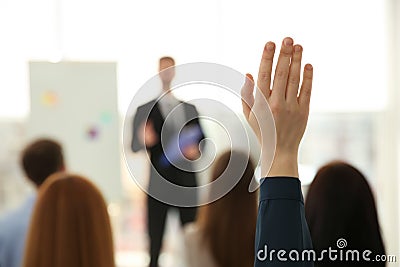 Woman raising hand to ask question at business training indoors, closeup Stock Photo