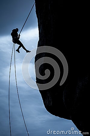 Woman rappeling silhouette Stock Photo