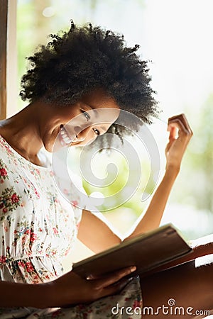 Woman, reading and book in home or relax, door way and sitting on floor for comfort with literature or novel for hobby Stock Photo