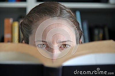 Woman reading a book in library Stock Photo