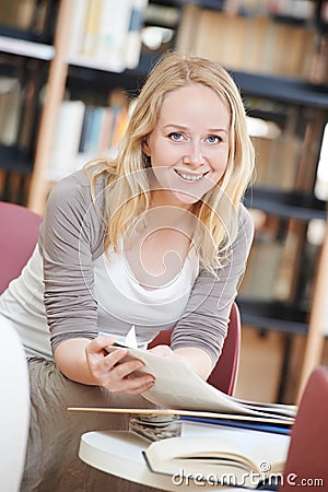 Woman reading book in library Stock Photo