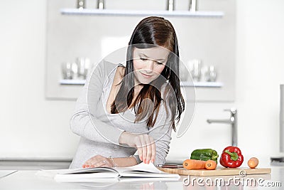 Woman reading cookery book Stock Photo