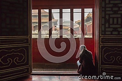 Woman reading at Forbiden city, Beijing Editorial Stock Photo