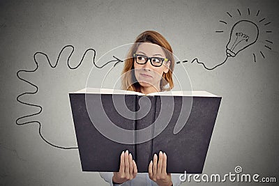 Woman reading a huge book has a good idea Stock Photo