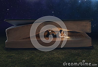 Woman reading inside a huge book Stock Photo