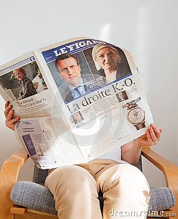 Woman reading Le Figaro with Emmanuel Macron and Marine Le Pen o Editorial Stock Photo