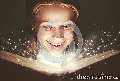 Woman reading a magic book Stock Photo